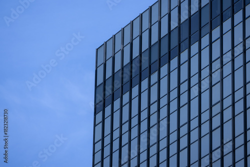 Wallpaper Mural A section of a modern building with many rectangular glass windows reflecting the clear Torontodigital.ca