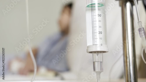 intravenous drip with blur kid patient on bed background. iv drips of medical fluid treatment.