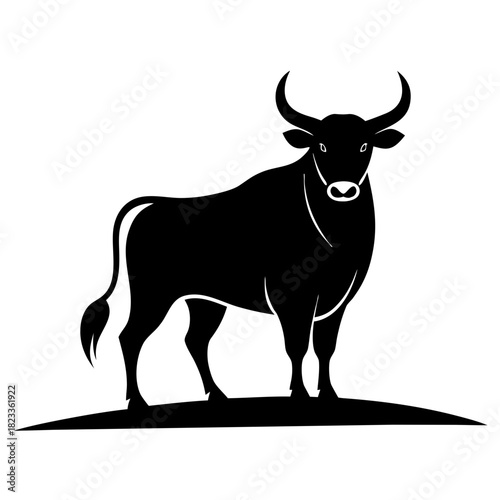 Powerful black bull standing proudly silhouette