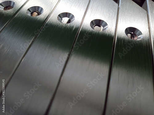 Details of furniture facades with an aluminum frame with countersunk holes. Silver color