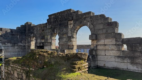 4K video of Prusias ad Hypium theater in Duzce. The ancient Roman ruins are nestled directly within the modern settlement of Konuralp, blending history with urban life.