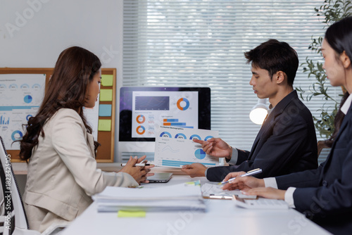 Business team analyzing financial data in meeting