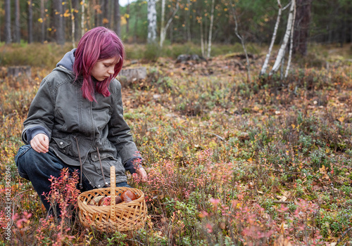 Girl foraging wild mushrooms in autumn forest