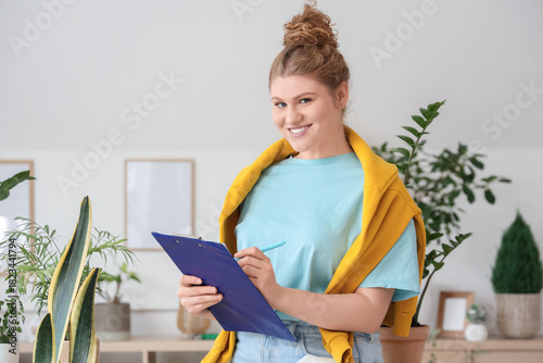 Female florist with clipboa...