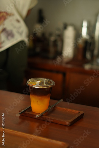 holding a cup of black coffee orange