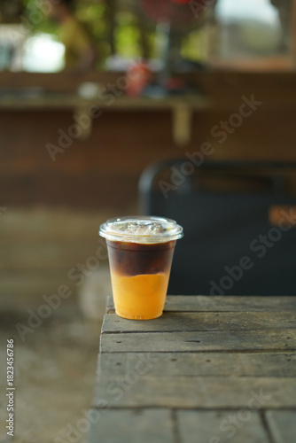 holding a cup of black coffee orange