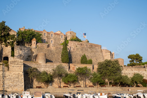 Fototapeta Naklejka Na Ścianę i Meble -  View of colourful Collioure, narrow streets and yellow, pink, orange houses, summer vacation destination town with historical buidings and beaches, Pyrenees-Orientales, France