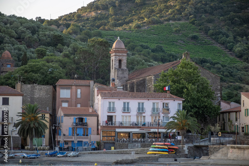 Fototapeta Naklejka Na Ścianę i Meble -  Morning view of colourful Collioure, narrow streets and yellow, pink, orange houses, summer vacation destination town with historical buidings and beaches, Pyrenees-Orientales, France