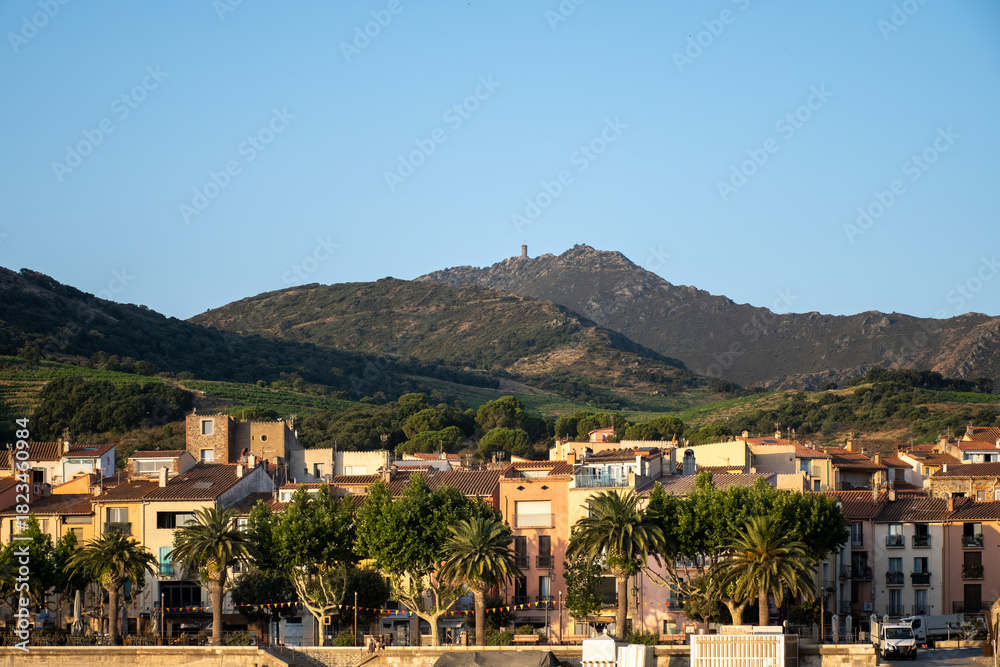 Obraz premium View of colourful Collioure, narrow streets and yellow, pink, orange houses, summer vacation destination town with historical buidings and beaches, Pyrenees-Orientales, France