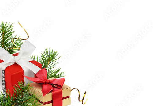 Red and golden gift boxes with ribbon bows and green fir twigs of Christmas tree in a holiday corner arrangement isolated on white or transparent background