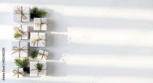 Christmas White Gifts and Pine Sprigs Flat Lay with Copy Space