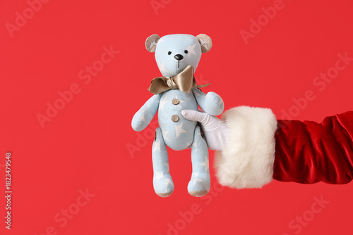 Santa Claus holding teddy b...
