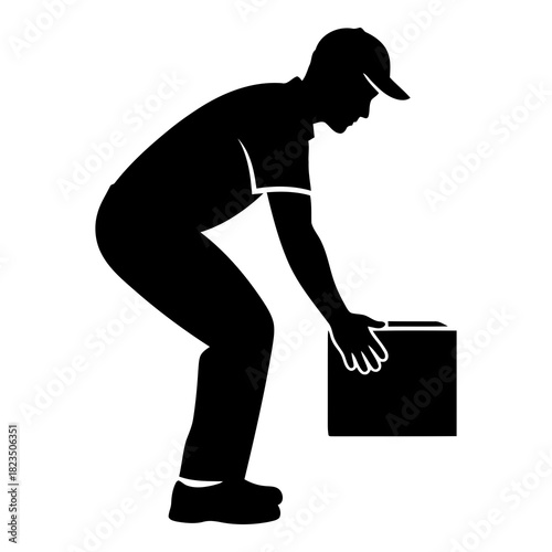 Safe lifting practices shown by worker picking up box for workplace safety awareness