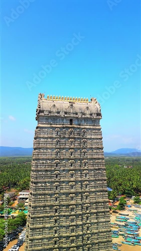 Aerial view of Murdeshwar Temple in Karnataka, India, showcasing the magnificent Shiva statue, temple complex, and coastal landscape along the Arabian Sea. Stunning drone footage captures the towering