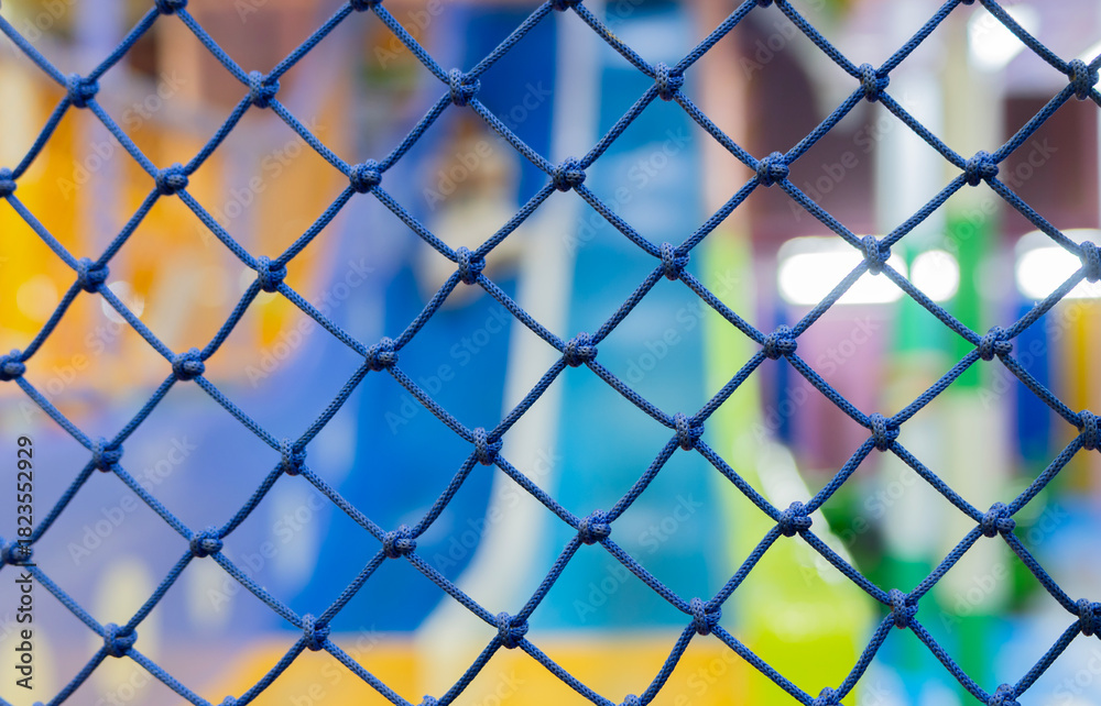 Fototapeta premium Close up on the blue safety net at the playground on indoor playground.