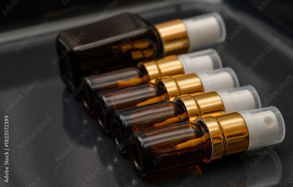 Fotografie Dark brown glass perfume bottles with atomizer