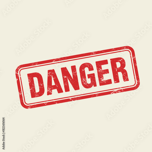 A red rectangular rubber stamp with the word DANGER in distressed uppercase letters on a light beige background.