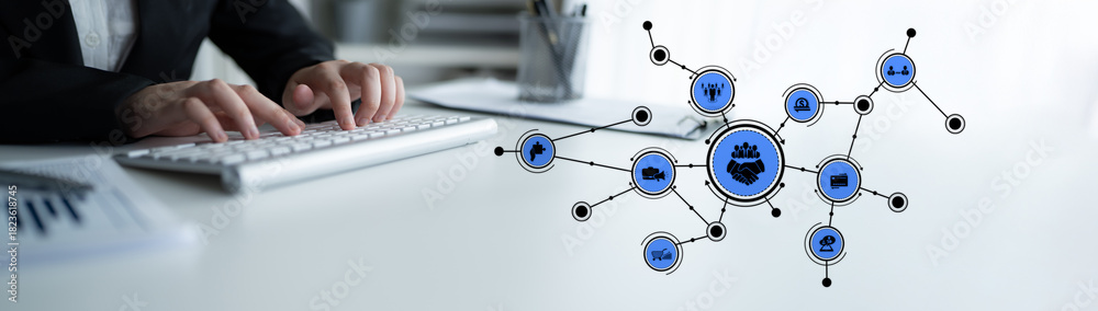 Fototapeta premium A businessman works at a modern workspace with a keyboard and digital connection icons, symbolizing the integration of technology in business and networking. Tessel