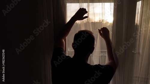 Silhouette of depressed, sad and lonely man in the apartment.