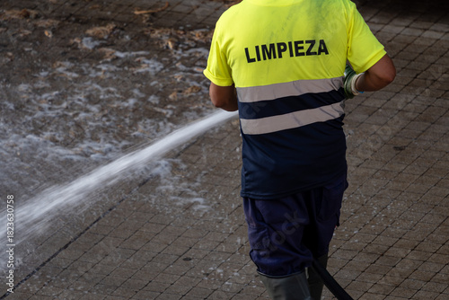 Street cleaning with a water hose
