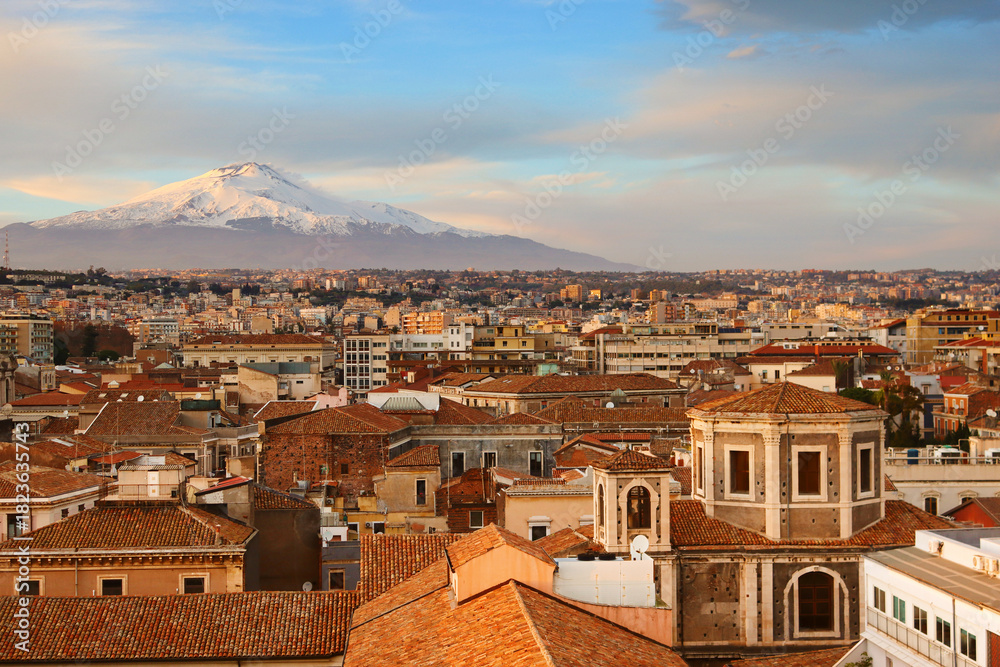 Obraz premium View of city Catania and Etna volcano at sunset in Sicily, Italy