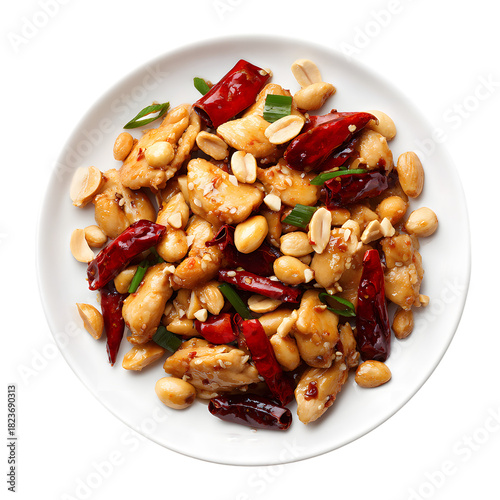 Kung Pao Chicken with peanuts, red peppers and chili on a white plate isolated on black background, spicy Chinese stir fry food dish top view.