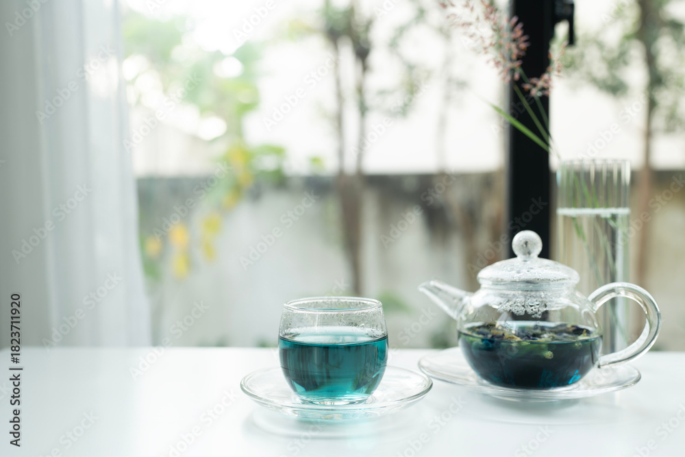 Fototapeta premium butterfly pea tea juice in a glass cup and white table