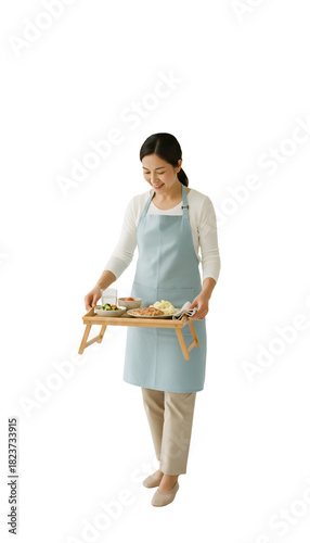 A person preparing a meal tray for a senior