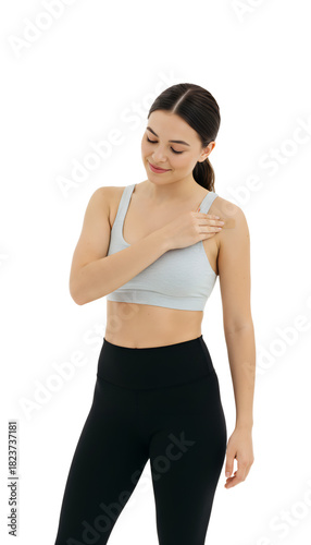 A young woman looking relieved applying a patch to her shoulder