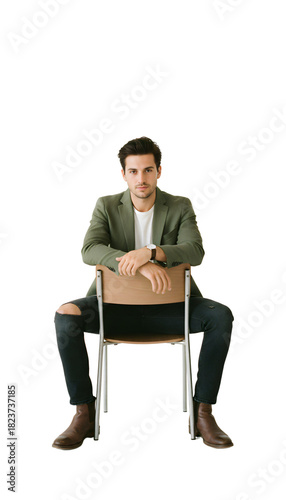 A young entrepreneur sitting backward on a chair looking cool