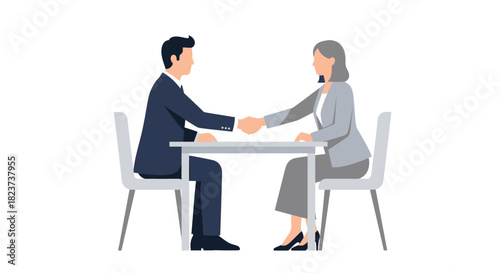 Business man and woman shaking hands across a table during a meeting.
