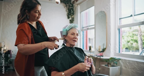 Old woman, hairdresser and hair rollers in beauty salon, curler or conversation. Hairstylist, tools or talking to customer for service, grooming or comb hairstyle with senior person in small business