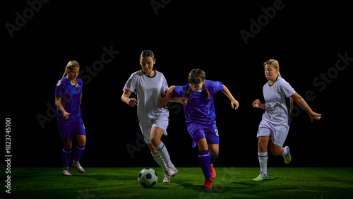 Teenage female soccer players competing for ball in dynamic midfield action. Concept of youth training programs, tactical education, match strategy materials, teamwork promotion.