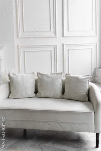 a comfortable light sofa in a bright room. modern interior design. organization of a space for recreation. vertical photo