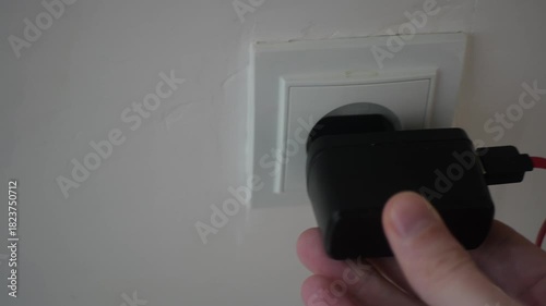 Hand Connecting Power Supply Block into Wall Socket Detailed View, Electrical Energy Distribution Concept, Electronic Device Charging Process with Sound, Household Electricity Usage
