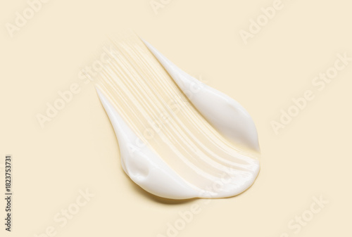 Close-up of cosmetic cream smear, smooth and shiny texture, pastel background