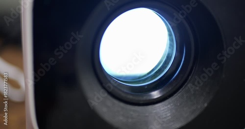 Detailed View Cinema Projector Front Lens Loading Operating System, Bright Light Illuminating Frame during Film Startup Process, Entertainment Media Technology, Digital Presentation Equipment