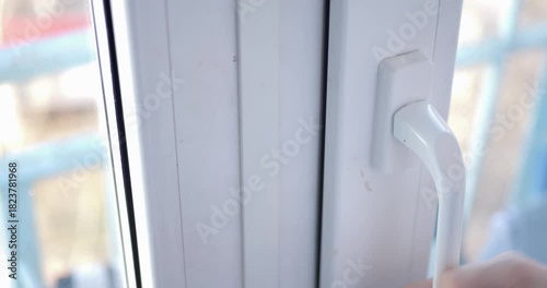 PVC Window Locking Unlocking Mechanism Close-Up Home Security Operation Double Glazed Glass Real-Time Interaction Residential Safety Sound Included 