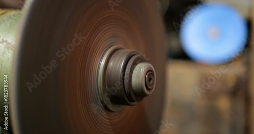 Grinding Wheel Close Up Spinning Down By Inertia. Slow Motion Deceleration, Physics Demonstration. Mechanical Engineering, Tool, Industry, Motion, Energy, Dynamic Process, Bearing