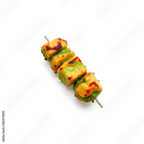 A succulent and freshly grilled green kebab, with a vibrant green hue, placed against a clean and pristine white background