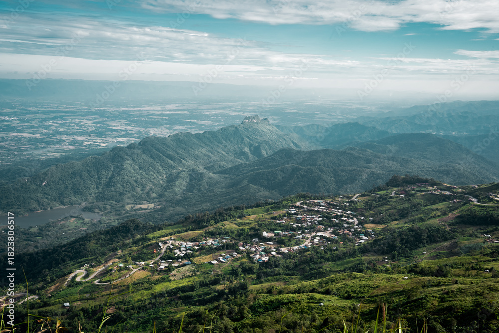 Fototapeta premium Beautiful mountain landscape with sea of mist, winding road, and resorts at Phu Thap Boek, Thailand.