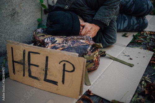Obraz na plátne Homeless man begging on street showing a help sign