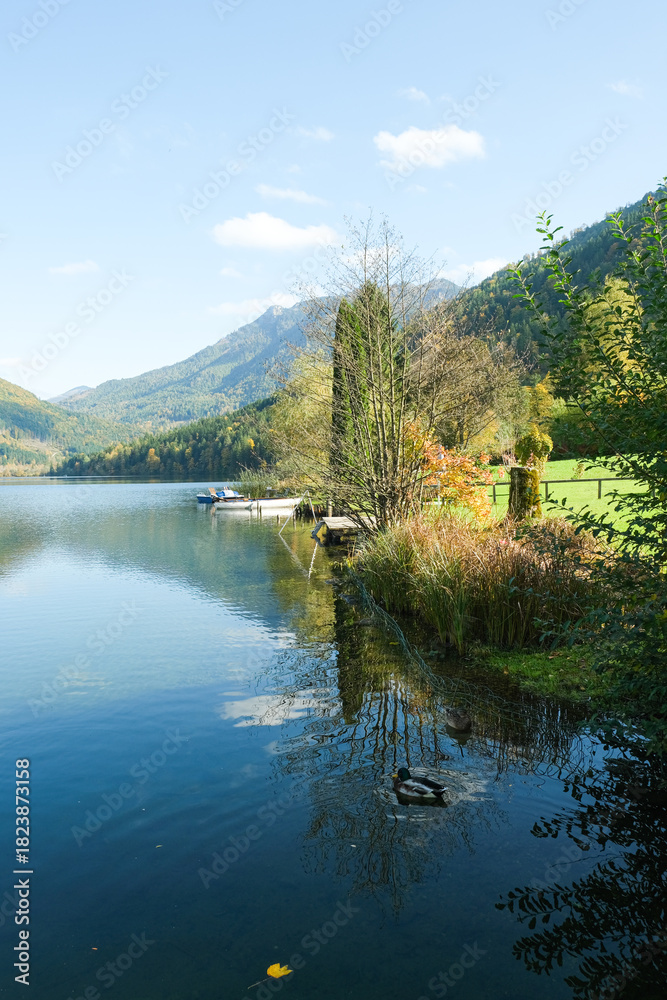 Fototapeta premium Autumn mountain landscape, mountains near lake, reflections in the water.