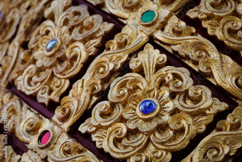 Golden Lanna-style Thai pattern panels decorated with gems for luxurious architecture and decoration.