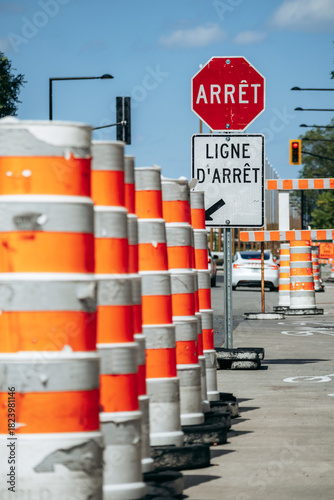 Montreal, Canada - August 14, 2025: Traffic barrels and stop sign at roadwork area near the Biodome
