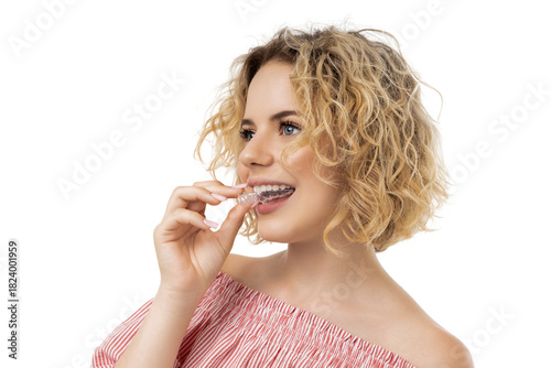 Young woman engages in teeth alignment with clear brace, isolated, PNG