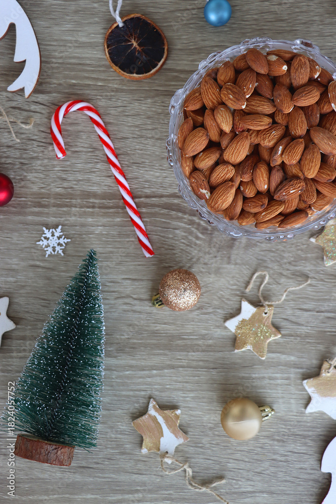 Obraz premium Various Christmas decorations, cookies, chocolate and nuts on wooden background. Flat lay.