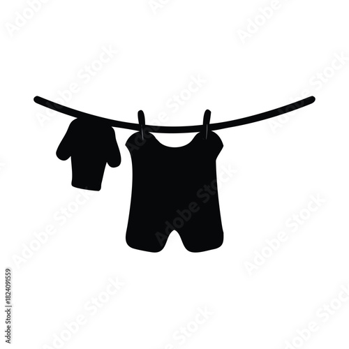 Two pieces of clothing are hanging on a clothesline with clothespins.