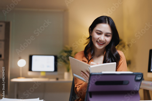 Young woman studying online, video calling with tablet