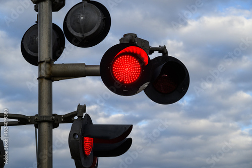 railroad crossing sign with red flashing light signal